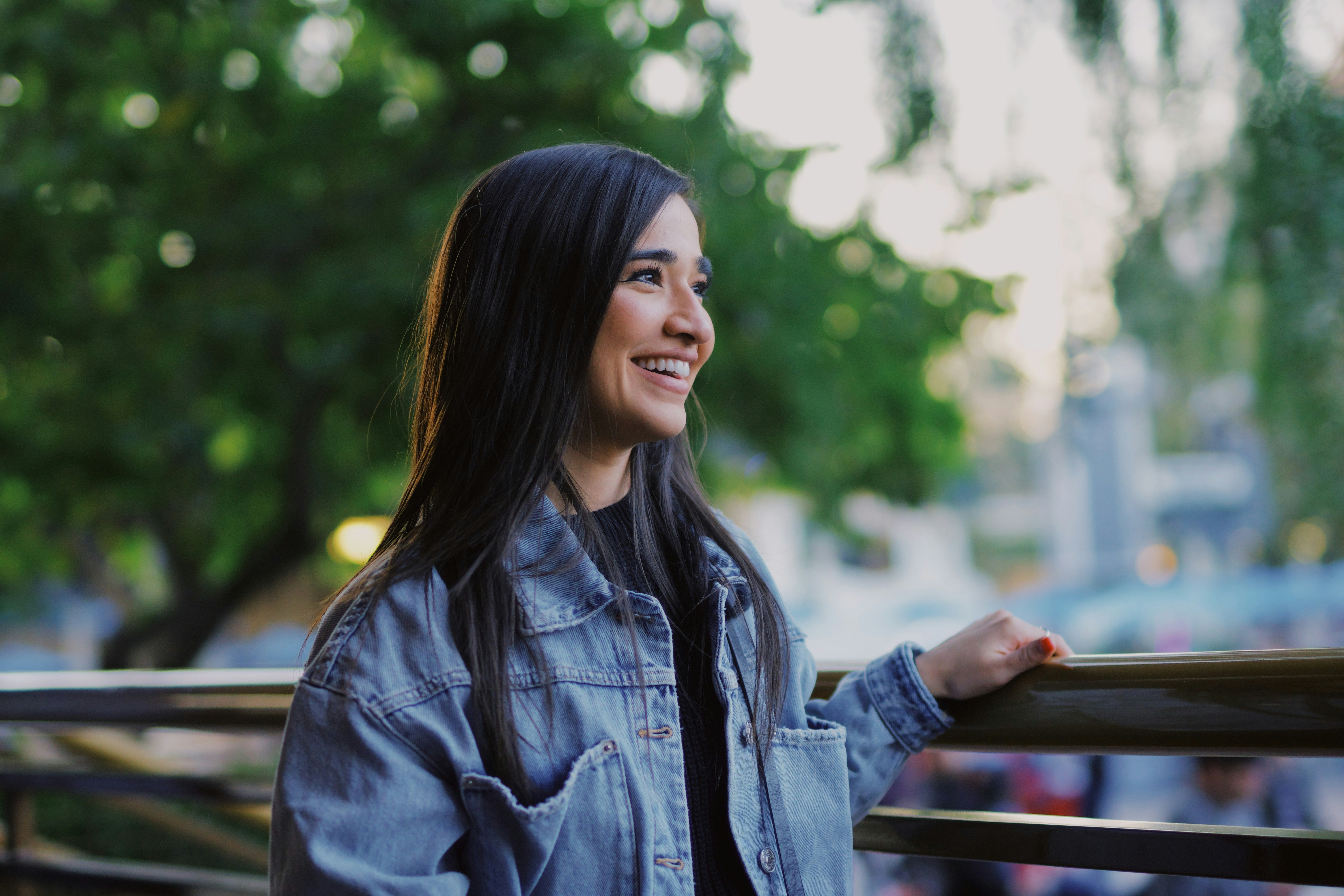 woman in blue denim jacket smiling